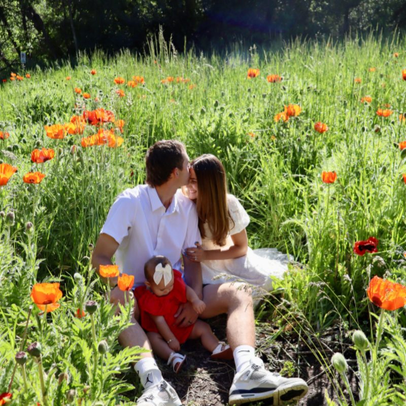 Morgan with her family in a field of orange flowers
